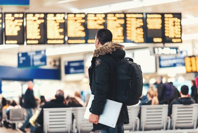 man in airport on his way to a ski holiday