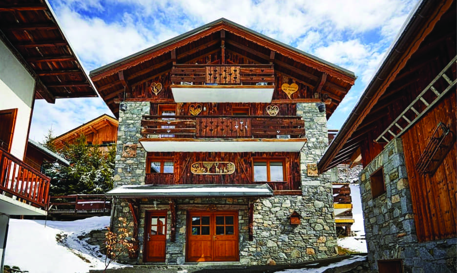 Chalet Daurel stone and timber exterior with carved wooden balconies