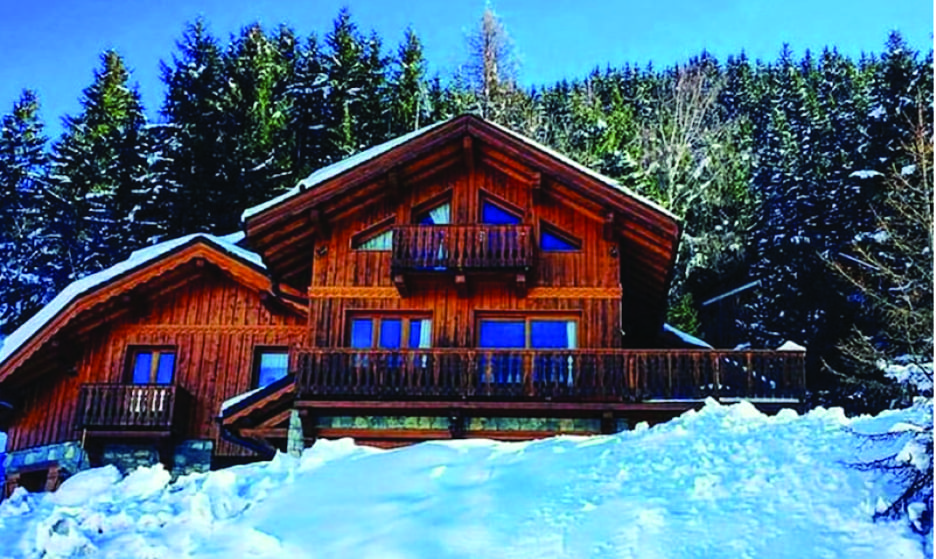 Chalet Evergreen timber exterior with snow in front
